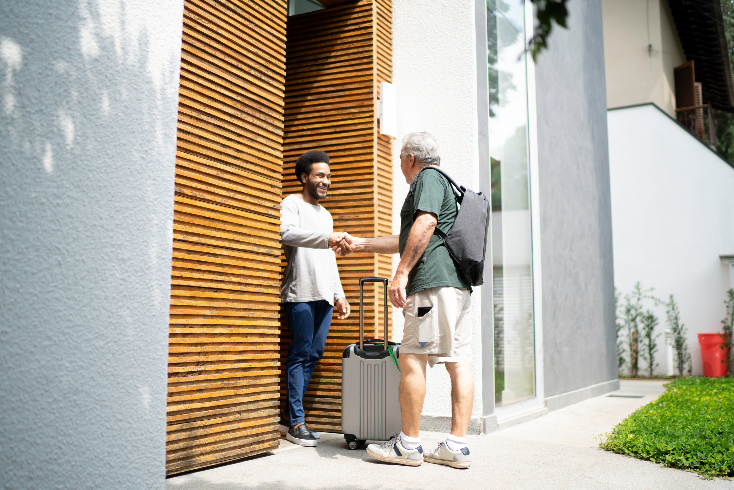 Host welcoming his guest in the doorway